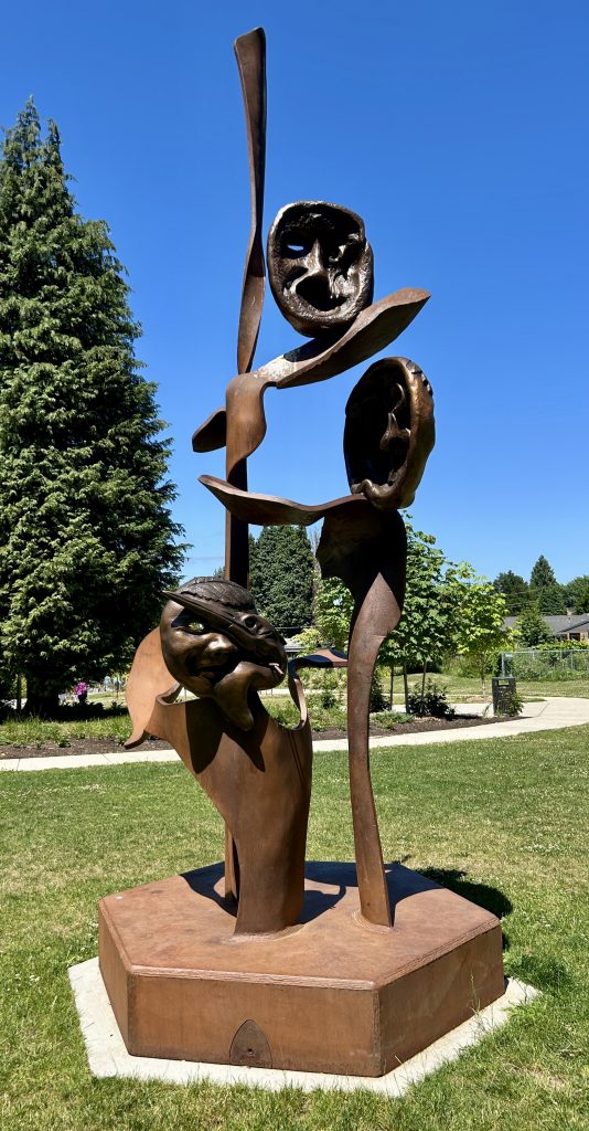 A bronze sculpture with First Nations elements in the sunlight at Errol Heights Park.